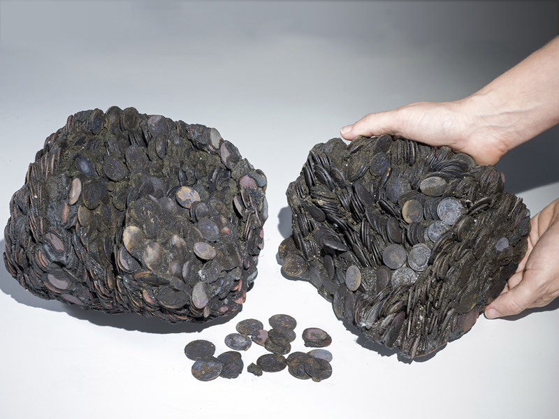 Chunks of solidified Roman coins (Image: Clara Amit/The Israel Antiquities Authority)